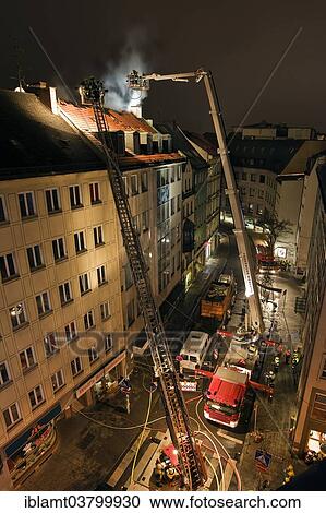 "Downtown fire, roof of a residential and commercial building on fire, fire brigade in action, Munich, Bavaria, Germany, Europe" View Large Photo Image Stock Image - "Downtown fire, roof of a residential and commercial building on fire, fire brigade in action, Munich, Bavaria, Germany, Europe". Fotosearch