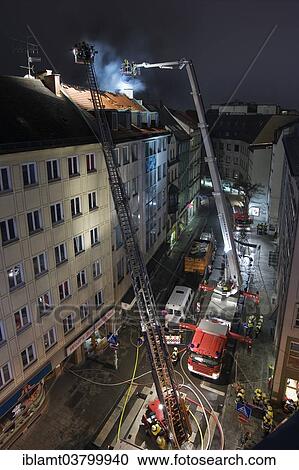 "Downtown fire, roof of a residential and commercial building on fire, fire brigade in action, Munich, Bavaria, Germany, Europe" View Large Photo Image Stock Image - "Downtown fire, roof of a residential and commercial building on fire, fire brigade in action, Munich, Bavaria, Germany, Europe". Fotosearch