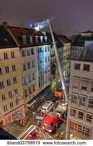"Downtown fire, roof of a residential and commercial building on fire, fire brigade in action, Munich, Bavaria, Germany, Europe" View Large Photo Image Stock Photo - "Downtown fire, roof of a residential and commercial building on fire, fire brigade in action, Munich, Bavaria, Germany, Europe". Fotosearch