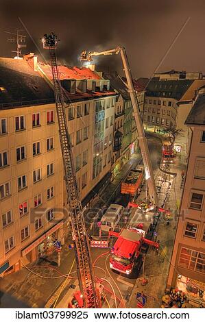 "Downtown fire, roof of a residential and commercial building on fire, fire brigade in action, Munich, Bavaria, Germany, Europe" View Large Photo Image Stock Photography - "Downtown fire, roof of a residential and commercial building on fire, fire brigade in action, Munich, Bavaria, Germany, Europe". Fotosearch