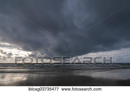 "Dramatic cloud formation over a North Sea beach, Henne Strand, Jutland, Denmark, Europe" View Large Photo Image Stock Photo - "Dramatic cloud formation over a North Sea beach, Henne Strand, Jutland, Denmark, Europe". Fotosearch