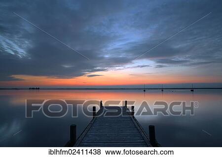 "Dramatic evening sky above the lake with a wooden pier in the foreground, Steinhude am Meer, Lower Saxony, Germany, Europe" View Large Photo Image Stock Photo - "Dramatic evening sky above the lake with a wooden pier in the foreground, Steinhude am Meer, Lower Saxony, Germany, Europe". Fotosearch