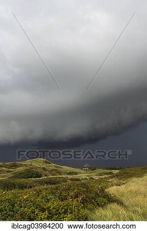 "Dramatic storm clouds over dunes, Henne Strand, Region of Southern Denmark, Denmark, Europe" View Large Photo Image Stock Image - "Dramatic storm clouds over dunes, Henne Strand, Region of Southern Denmark, Denmark, Europe". Fotosearch