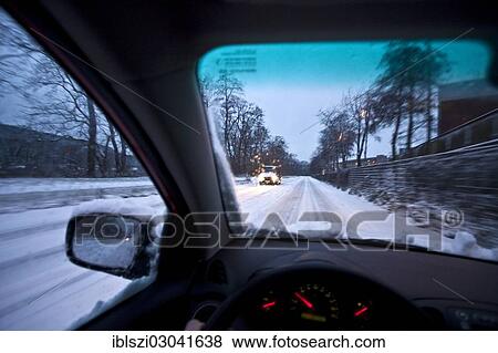 Stock Photo - "Driving a car in snow at dusk, Witten, North Rhine-Westphalia, Germany, Europe". Fotosearch