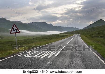 "Driving on the left side of the road, with the marking """"Slow"""" on the road in the Highlands, Scotland, United Kingdom, Europe" View Large Photo Image Stock Image - "Driving on the left side of the road, with the marking """"Slow"""" on the road in the Highlands, Scotland, United Kingdom, Europe". Fotosearch