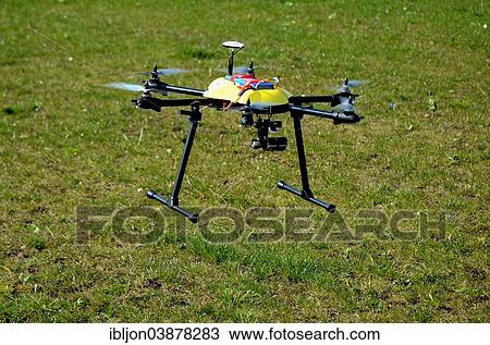 Stock Image - Drone carrying a camera. Fotosearch