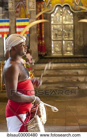 "Drummer standing in front of the golden gate, Buddhist shrine, Sri Dalada Maligawa, Temple of the Tooth in Kandy, Kandy, Sri Lanka, Asia" View Large Photo Image Stock Image - "Drummer standing in front of the golden gate, Buddhist shrine, Sri Dalada Maligawa, Temple of the Tooth in Kandy, Kandy, Sri Lanka, Asia". Fotosearch
