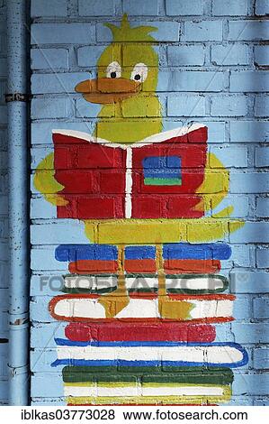 "Duck figure reading a book, mural in a school playground, Germany, Europe" View Large Photo Image Stock Photo - "Duck figure reading a book, mural in a school playground, Germany, Europe". Fotosearch