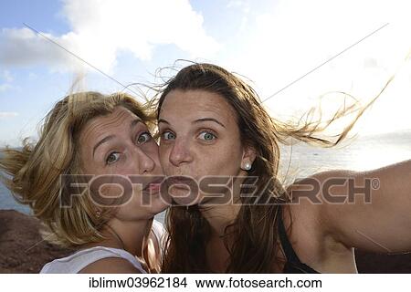Picture - "Duckface selfie, Suglie, Suglies, new web trend, two young women taking a self-portrait with a mobile phone, Lanzarote, Canary Islands, Spain, Europe". Fotosearch