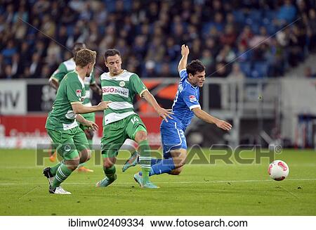 Picture - "Duel, foul on Kevin VOLLAND, TSG 1899 Hoffenheim, right, by Edgar Prib, SpVgg Greuther Furth, center, Wirsol Rhein-Neckar-Arena, Sinsheim-Hoffenheim, Baden-Wuerttemberg, Germany, Europe". Fotosearch
