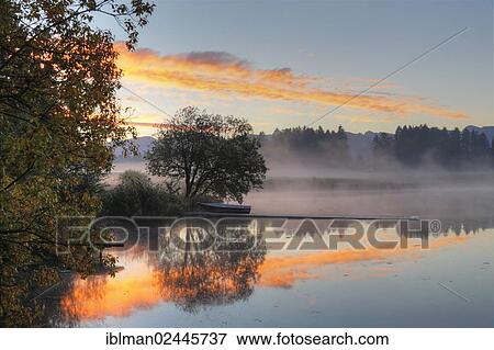 Stock Photo - "Early morning mood at Huttlerweiher, community of Rosshaupten, Ostallgaeu, Allgaeu, Swabia, Bavaria, Germany, Europe". Fotosearch