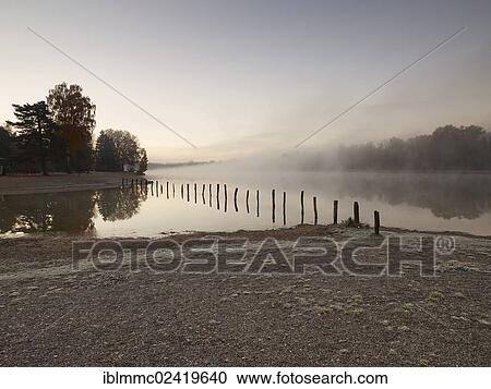 Early morning mood at Kuhsee lake with a bathing bay, Augsburg, Swabia, Bavaria, Germany, Europe View Large Photo Image Stock Image - Early morning mood at Kuhsee lake with a bathing bay, Augsburg, Swabia, Bavaria, Germany, Europe. Fotosearch