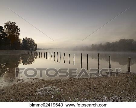 Early morning mood at Kuhsee lake with a bathing bay, Augsburg, Swabia, Bavaria, Germany, Europe View Large Photo Image Stock Image - Early morning mood at Kuhsee lake with a bathing bay, Augsburg, Swabia, Bavaria, Germany, Europe. Fotosearch