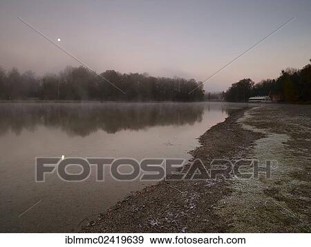 Early morning mood at Kuhsee lake with a view towards Hochablass wier, Augsburg, Swabia, Bavaria, Germany, Europe View Large Photo Image Stock Photo - Early morning mood at Kuhsee lake with a view towards Hochablass wier, Augsburg, Swabia, Bavaria, Germany, Europe. Fotosearch