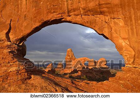Stock Photo - "Early morning mood at Turret Arch seen through North Window, Windows Section, Arches National Park, Moab, Utah, United States of America, USA". Fotosearch