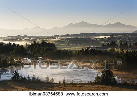 Stock Photo - "Early morning mood on Schwaigsee lake, Wildsteig, Pfaffenwinkel region, Upper Bavaria, Bavaria, Germany, Europe". Fotosearch