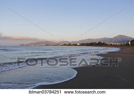 Stock Image - "Early morning on the beach with Iskele district, Anamur, Mersin Province, Turkish Riviera, Turkey, Asia". Fotosearch