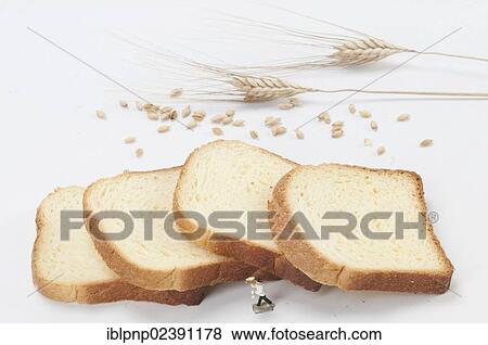 Ears of wheat and slices of bread View Large Photo Image Stock Photo - Ears of wheat and slices of bread. Fotosearch