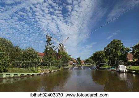 "East Frisian countryside, overlooking the Knockster Tief river course on the landmark of Hinte, smock mill, Emden, East Frisia, Lower Saxony, Germany, Europe" View Large Photo Image Stock Image - "East Frisian countryside, overlooking the Knockster Tief river course on the landmark of Hinte, smock mill, Emden, East Frisia, Lower Saxony, Germany, Europe". Fotosearch