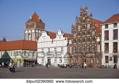 Stock Image - "East side of the market square with St. Mary's Church and the Marimar Cafe, building with a historic brick gable, Greifswald, Mecklenburg-Western Pomerania, Germany, Europe". Fotosearch