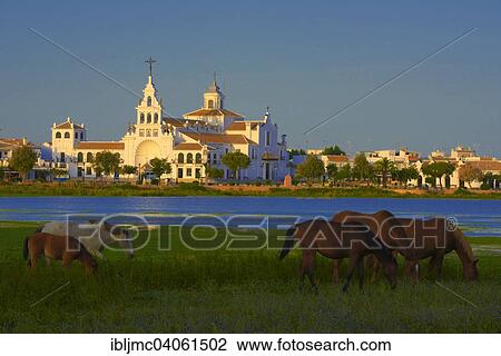 Stock Image - "El Rocio village and Ermita del Rocio hermitage in morning light, El Rocio, Almonte, Marismas de Donana, Huelva province, Andalusia, Spain, Europe". Fotosearch