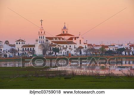 Stock Photo - "El Rocio village and Ermita del Rocio hermitage at sunset, El Rocio, Huelva province, Andalusia, Spain, Europe". Fotosearch