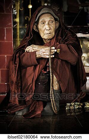 "Elderly Buddhist nun sitting with prayer beads at the Mahamuni Pagoda in Mandalay, Myanmar, Burma, Southeast Asia, Asia" View Large Photo Image Picture - "Elderly Buddhist nun sitting with prayer beads at the Mahamuni Pagoda in Mandalay, Myanmar, Burma, Southeast Asia, Asia". Fotosearch