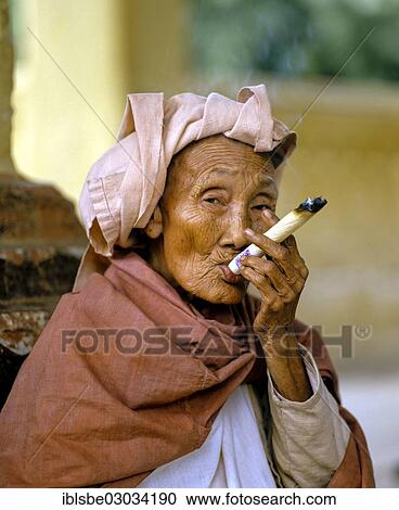 "Elderly Burmese woman smoking a Cheerot cigar and wearing a headscarf, beggar, Mingun, Mingun, Mandalay, Sagaing-Division, Myanmar, Burma, Asia" View Large Photo Image Stock Image - "Elderly Burmese woman smoking a Cheerot cigar and wearing a headscarf, beggar, Mingun, Mingun, Mandalay, Sagaing-Division, Myanmar, Burma, Asia". Fotosearch