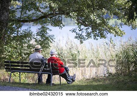 "Elderly couple sitting on a bench beside the lake, Weissensee lake, Carinthia, Austria, Europe" View Large Photo Image Stock Photography - "Elderly couple sitting on a bench beside the lake, Weissensee lake, Carinthia, Austria, Europe". Fotosearch