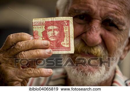 "Elderly Cuban man holding a 3-peso bill with the portrait of Ernesto Che Guevara in his hand, Havana, Cuba, North America" View Large Photo Image Stock Photo - "Elderly Cuban man holding a 3-peso bill with the portrait of Ernesto Che Guevara in his hand, Havana, Cuba, North America". Fotosearch