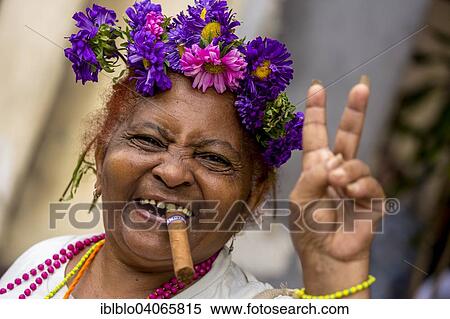 "Elderly Cuban woman with flower headdress and cigar, making peace sign, Havana, Cuba, North America" View Large Photo Image Stock Photography - "Elderly Cuban woman with flower headdress and cigar, making peace sign, Havana, Cuba, North America". Fotosearch