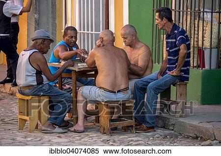 "Elderly Cubans sitting at a table on the road, playing dominoes, Trinidad, Sancti Spiritus Province, Cuba, North America" View Large Photo Image Stock Photography - "Elderly Cubans sitting at a table on the road, playing dominoes, Trinidad, Sancti Spiritus Province, Cuba, North America". Fotosearch