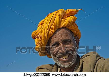 "Elderly friendly Indian man with a yellow turban, portrait, Pushkar, Rajasthan, India, Asia" View Large Photo Image Stock Photo - "Elderly friendly Indian man with a yellow turban, portrait, Pushkar, Rajasthan, India, Asia". Fotosearch