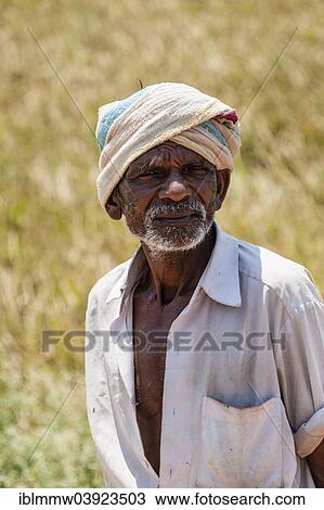 Stock Image - "Elderly Indian man with turban near a field Uttamapalaiyam, Tamil Nadu, India, Asia". Fotosearch