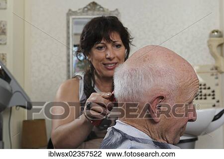 Stock Image - "Elderly man at a hairdresser's, hair cutting, Baden-Wuerttemberg, Germany, Europe". Fotosearch