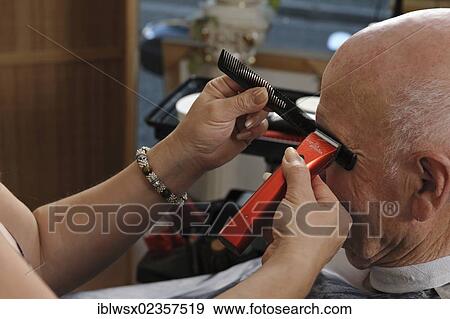 Stock Photo - "Elderly man at a hairdresser's, eyebrows cutting, Baden-Wuerttemberg, Germany, Europe". Fotosearch