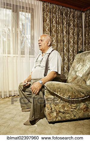 Elderly man holding a remote control View Large Photo Image Stock Image - Elderly man holding a remote control. Fotosearch