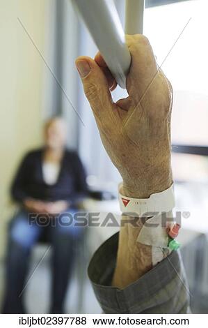 Stock Photo - "Elderly man in a hospital, detail, hand holding a hand grip in a hospital bed". Fotosearch