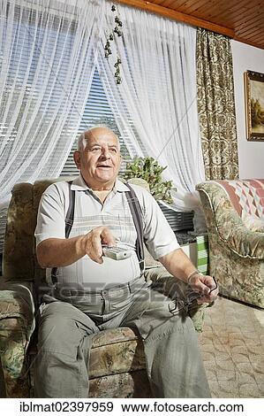 Elderly man operating a remote control View Large Photo Image Stock Photo - Elderly man operating a remote control. Fotosearch