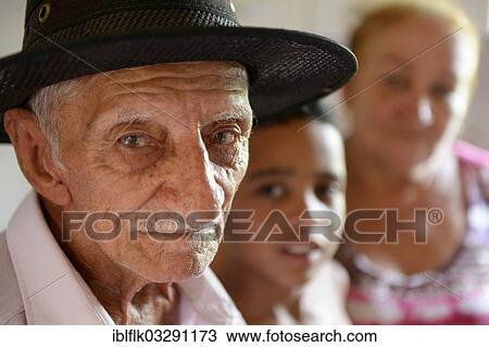 "Elderly man, portrait, his grandson, 2 years, and his wife at back, Poxoreo, Mato Grosso, Brazil, South America" View Large Photo Image Stock Image - "Elderly man, portrait, his grandson, 2 years, and his wife at back, Poxoreo, Mato Grosso, Brazil, South America". Fotosearch