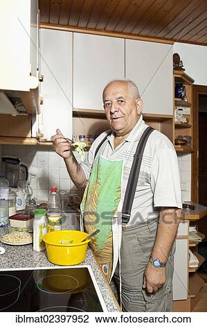 Elderly man preparing a salad in the kitchen View Large Photo Image Stock Image - Elderly man preparing a salad in the kitchen. Fotosearch