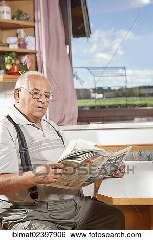 Elderly man reading a newspaper View Large Photo Image Stock Photograph - Elderly man reading a newspaper. Fotosearch