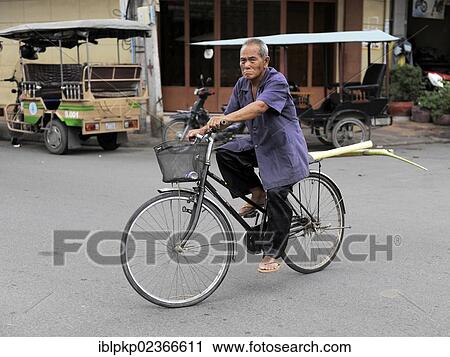 "Elderly man riding a bike, Phnom Penh, Cambodia, Southeast Asia, Asia" View Large Photo Image Stock Image - "Elderly man riding a bike, Phnom Penh, Cambodia, Southeast Asia, Asia". Fotosearch