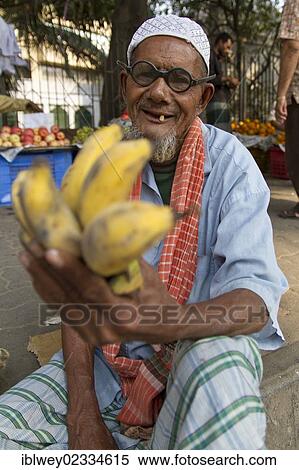 Stock Photography - "Elderly man selling bananas on the roadside, Dhaka, Bangladesh, South Asia, Asia". Fotosearch
