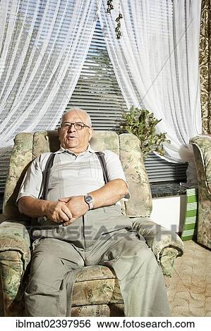 Elderly man sitting in a recliner View Large Photo Image Stock Photograph - Elderly man sitting in a recliner. Fotosearch