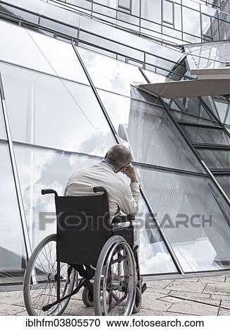 "Elderly man sitting in a wheelchair in front of a modern building, Lower Saxony, Germany, Europe" View Large Photo Image Stock Image - "Elderly man sitting in a wheelchair in front of a modern building, Lower Saxony, Germany, Europe". Fotosearch