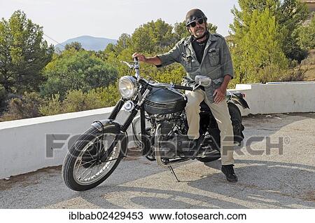 "Elderly man sitting on a Triumph Tiger 500cc motorbike, built in 1956, English motorcycle, Altea, Costa Blanca, Spain, Europe, PublicGround, Europe" View Large Photo Image Stock Image - "Elderly man sitting on a Triumph Tiger 500cc motorbike, built in 1956, English motorcycle, Altea, Costa Blanca, Spain, Europe, PublicGround, Europe". Fotosearch