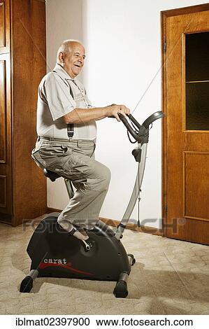 Elderly man sitting on an exercise bike View Large Photo Image Stock Image - Elderly man sitting on an exercise bike. Fotosearch