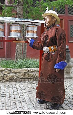 "Elderly man wearing a traditional deel while rotating prayer wheels in the Buddhist Gandan Monastery, Ulaanbaatar, Mongolia, Asia" View Large Photo Image Stock Photo - "Elderly man wearing a traditional deel while rotating prayer wheels in the Buddhist Gandan Monastery, Ulaanbaatar, Mongolia, Asia". Fotosearch