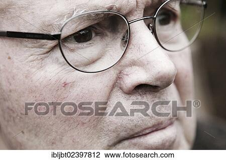 Stock Image - "Elderly man wearing glasses, portrait". Fotosearch